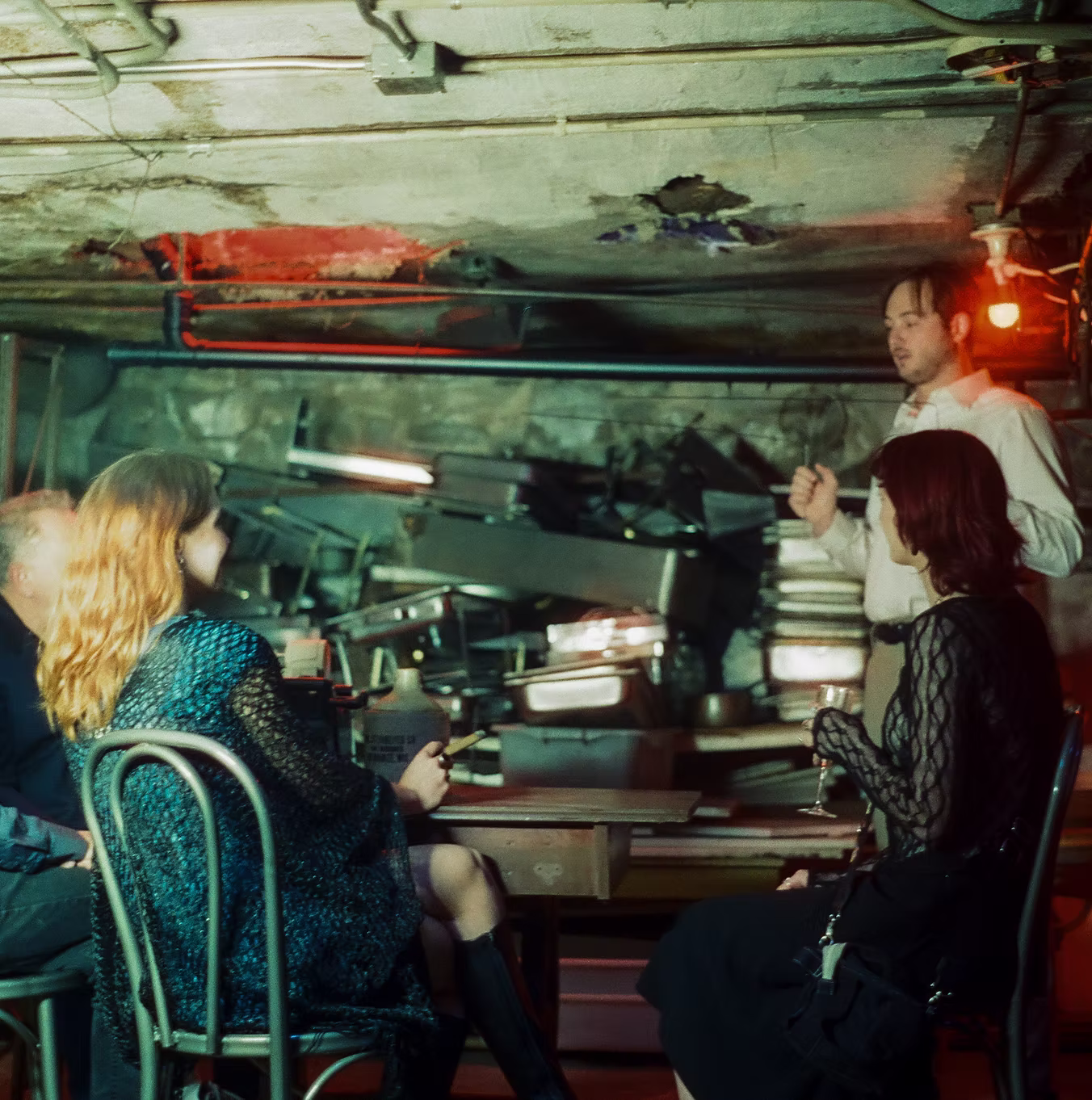 People gathered in a dimly lit room.