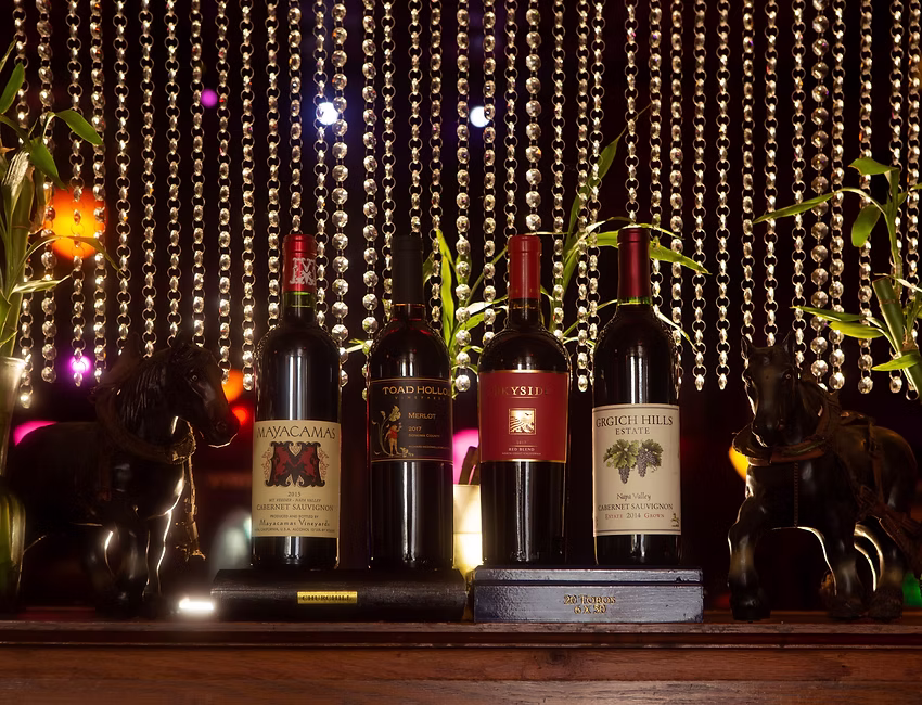 Wine bottles on decorated shelf